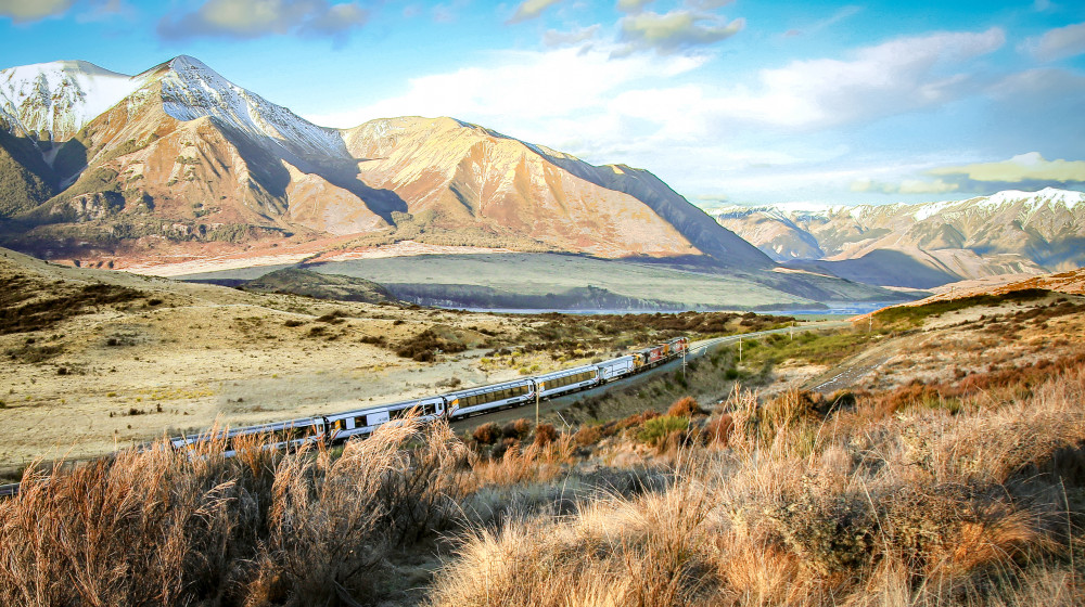 The TranzAlpine train ventures through a fantasy world of snow-capped mountains and icy rivers