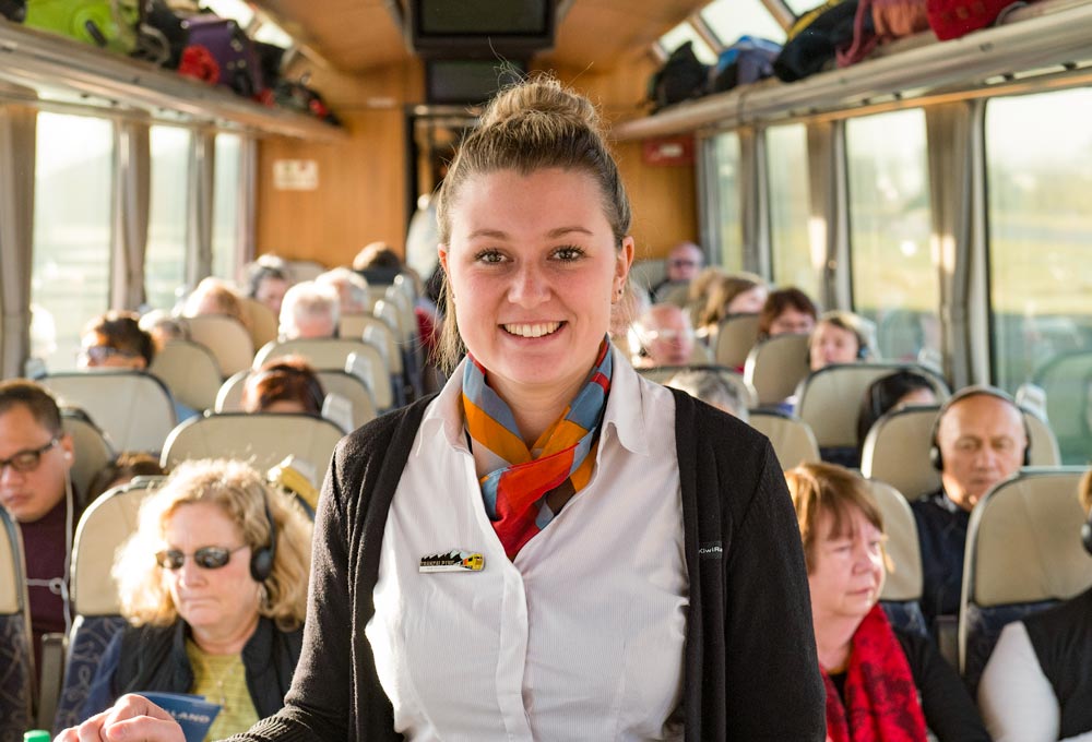 Scenic train crew member Rachael Martin serving in our Scenic Class Carriage